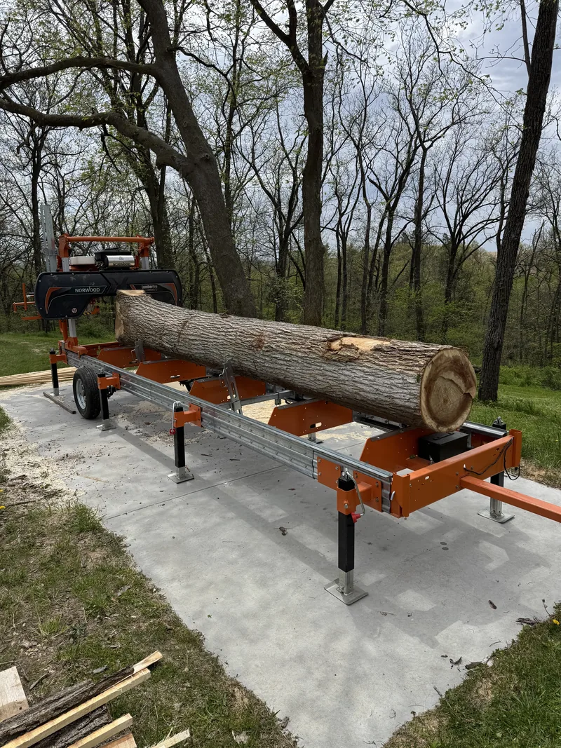 Hardwood log loaded on a Norwood portable band sawmill, ready to be milled into lumber